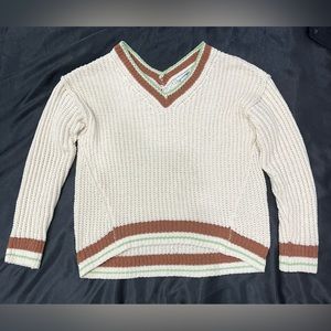 Rue 21 Brand new sweater with light green and brown details. Longer in the back